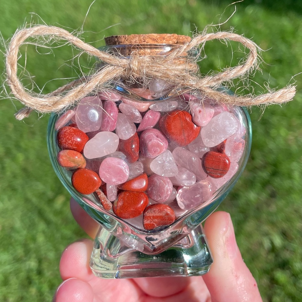 Heart shaped glass bottle with rhodonite, rose quartz, and red jasper chips